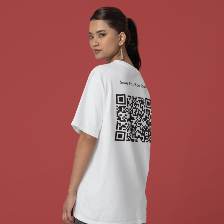 A person is seen from behind, wearing a white t-shirt with "Scan In, Zen Out" and a QR code on the back, against a red background.