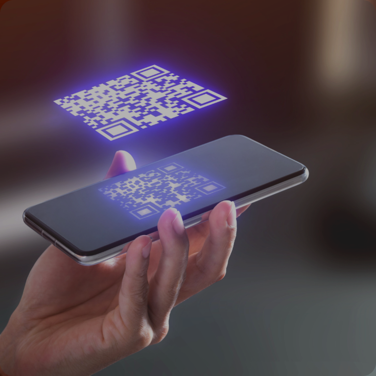 A futuristic depiction of a person's hand holding a smartphone, with a holographic QR code projection emitting from the screen, set against a softly blurred background.