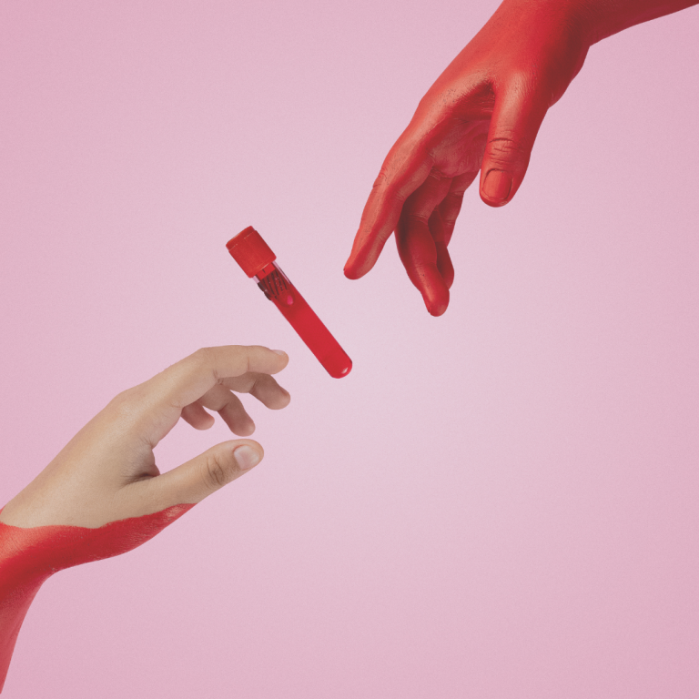 Artistic representation of a blood donation process where a hand in red paint reaches towards another with a test tube of blood, set against a pink background.